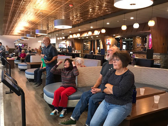 An excited group of people bowling