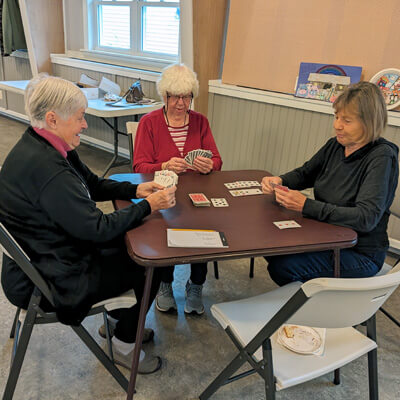 Three women playing a card game