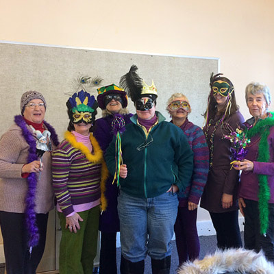 A group wearing Mardi Gras masks