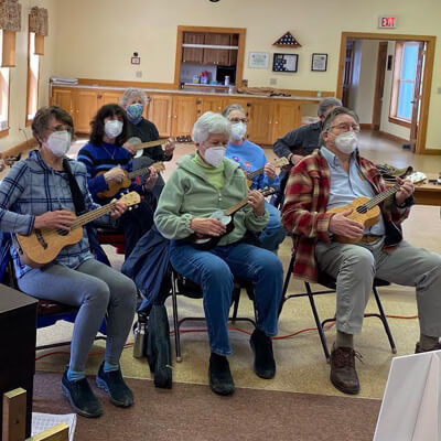 A group learning to play the Ukulele 